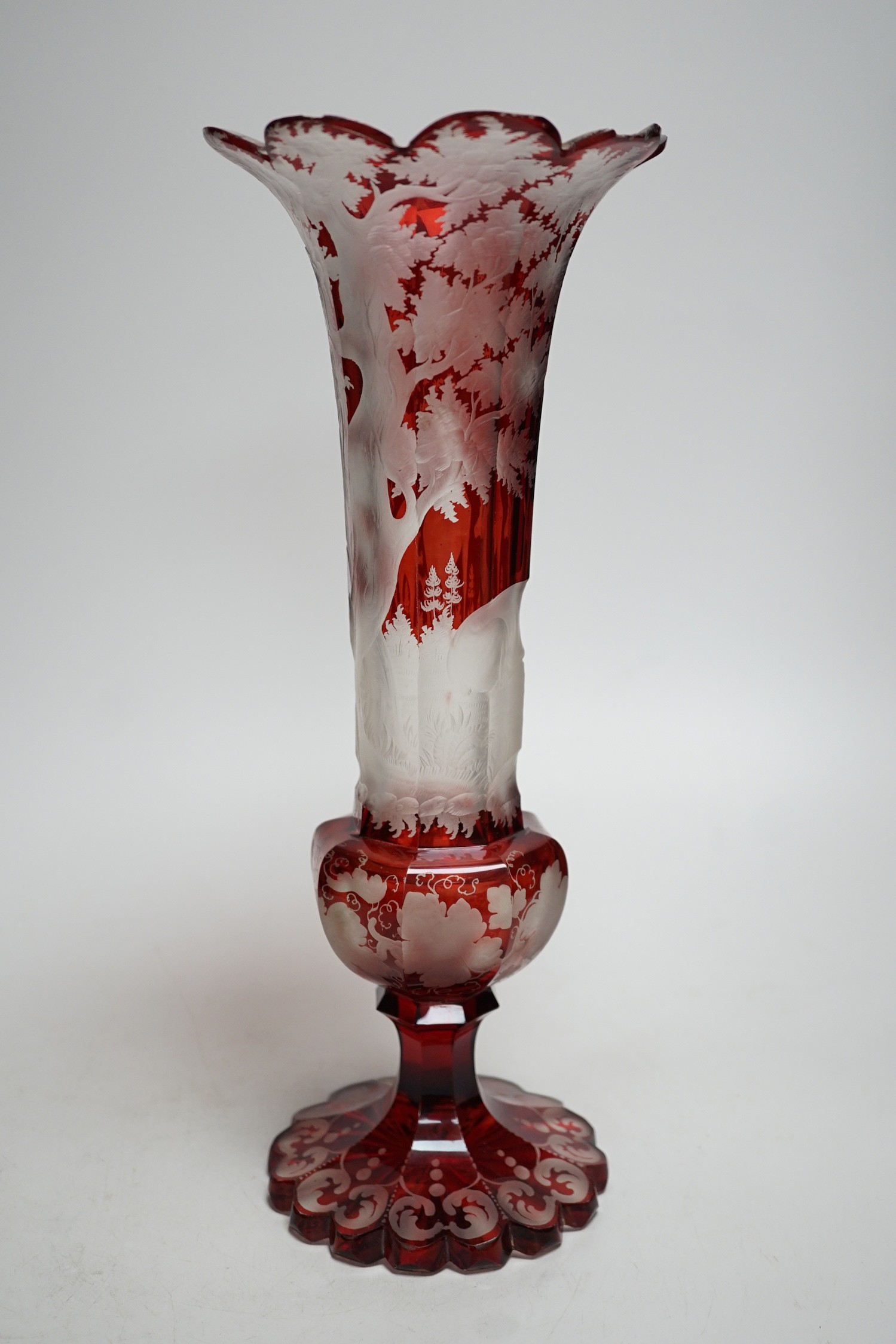 A Bohemian wheel engraved ruby glass vase (a.f.). 35cm tall